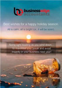A sunset over the ocean with a glowing jar on the beach and holiday greetings from Business Edge Accountants