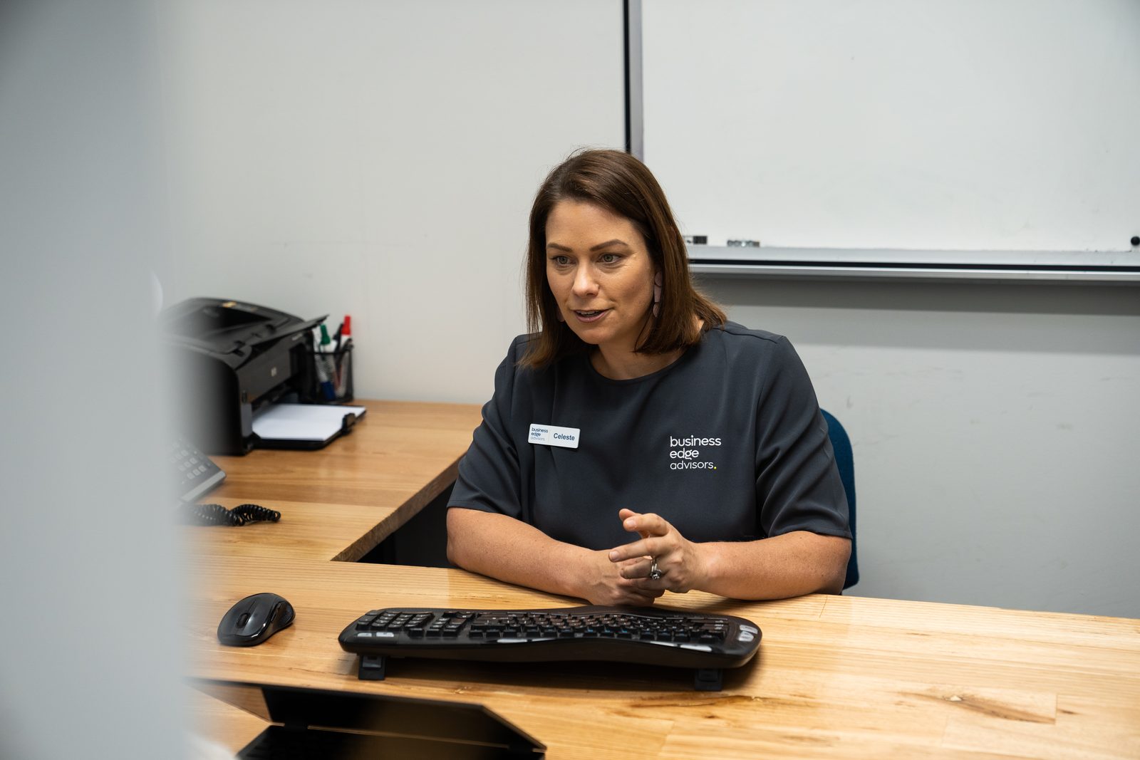 A Business Edge Advisors team member at the reception desk