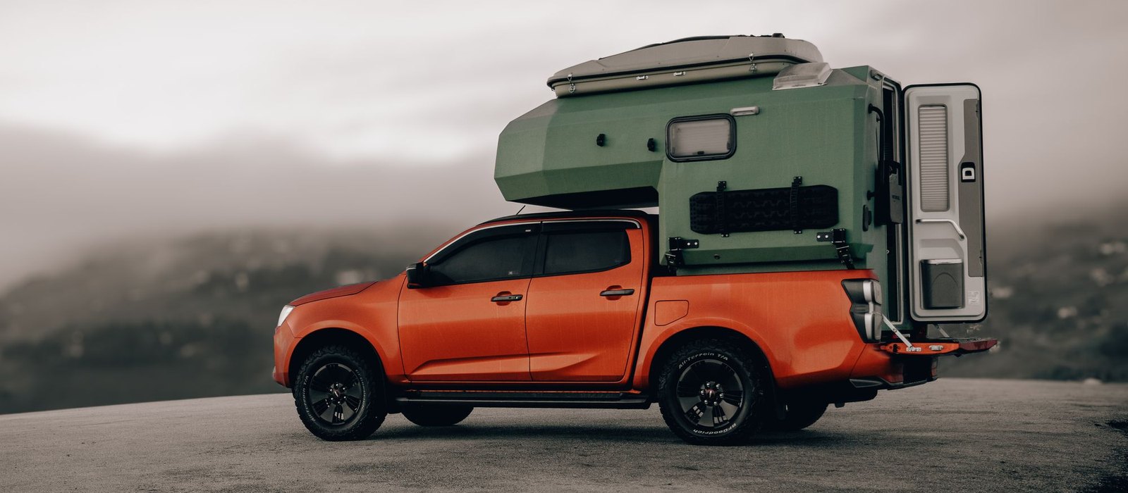 A dual cab ute carrying a slide-on camper