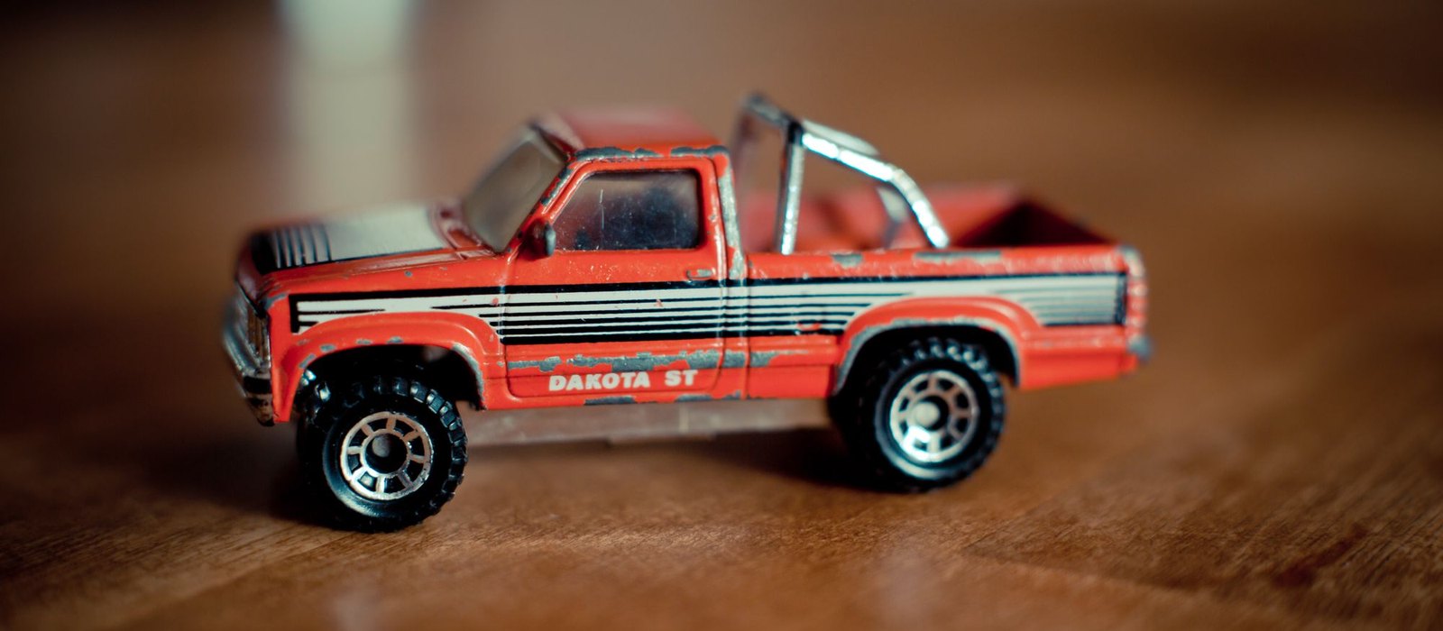 A die cast toy pickup truck photographed side on