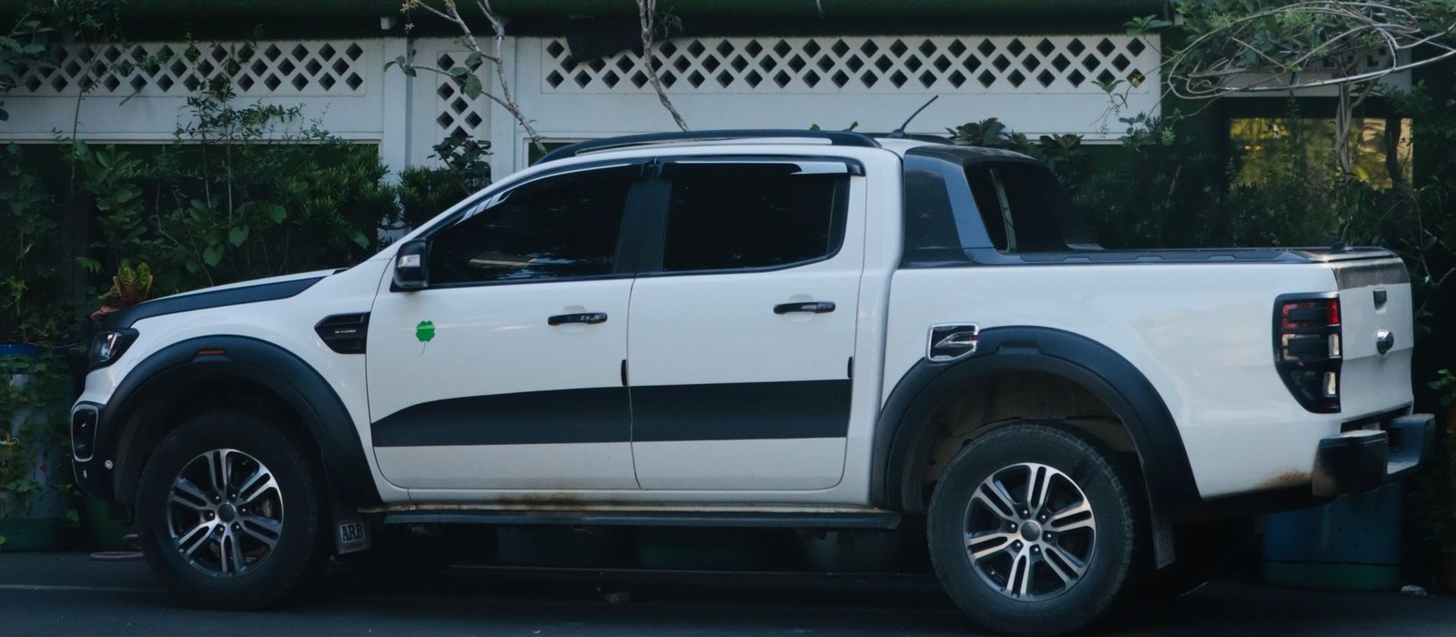 A white Ford Ranger dual cab photographed side on